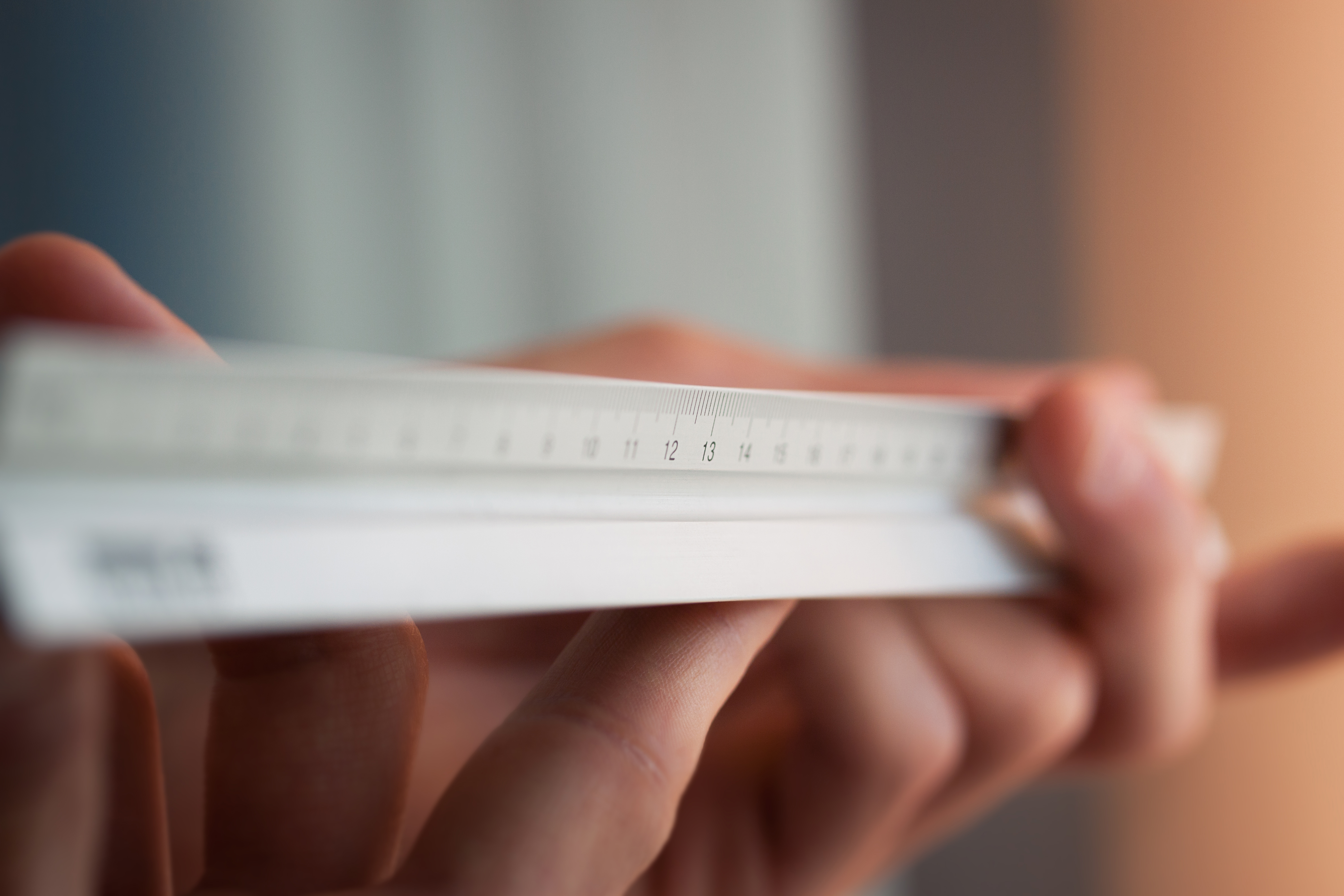 Architect holding a ruler for measuring. closeup, selective focus